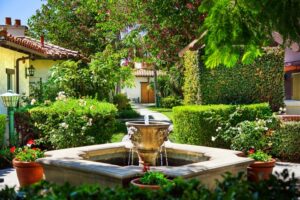 Outdoor garden with lush foliage and a small fountain