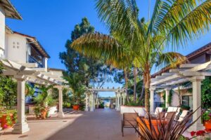 Outdoor patio with tropical plants and shaded seating areas