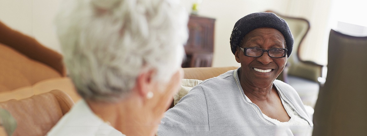 Two elderly women sitting and chatting