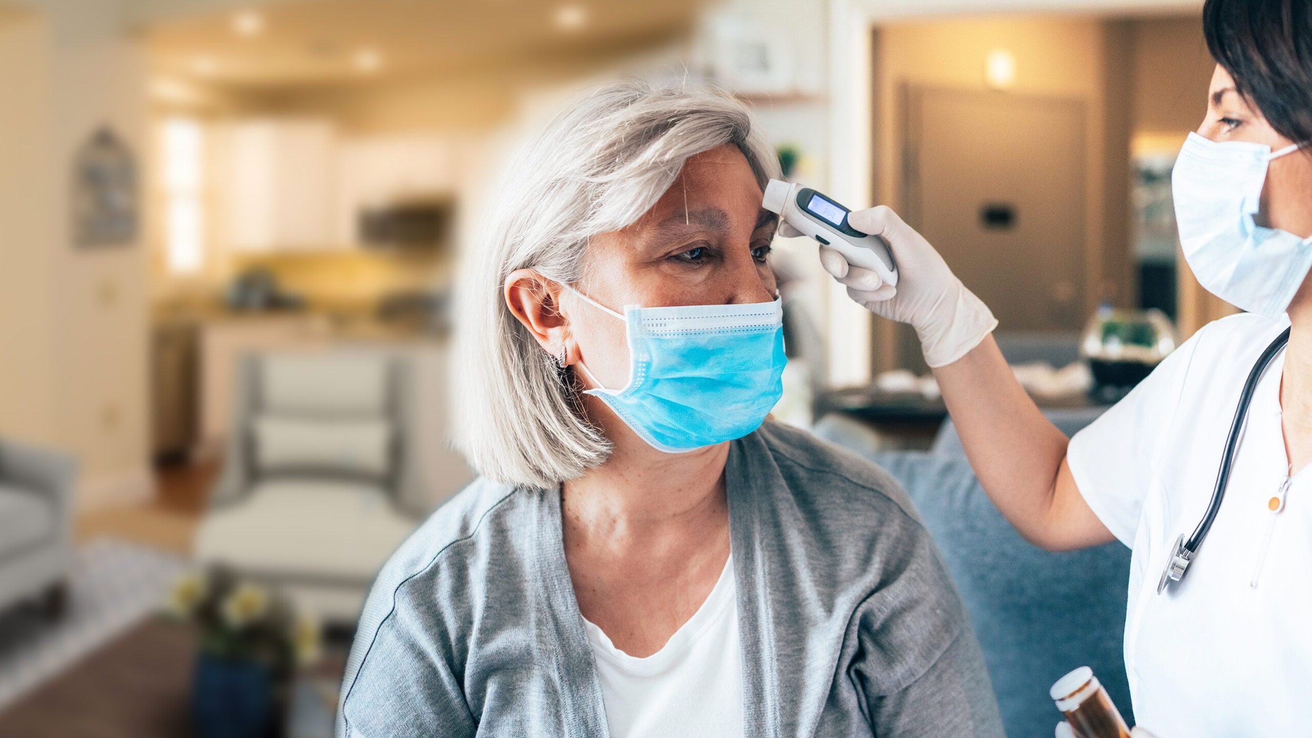 nurse taking a residents temperature