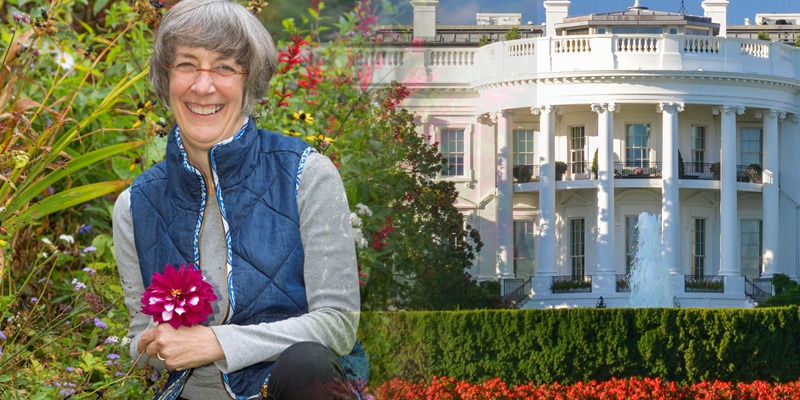 woman in a garden in front of the whitehouse