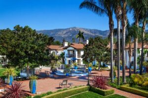 Aerial view of Covenant Living of Samarkand with mountain view and an outdoor patio with fountain and tropical plants